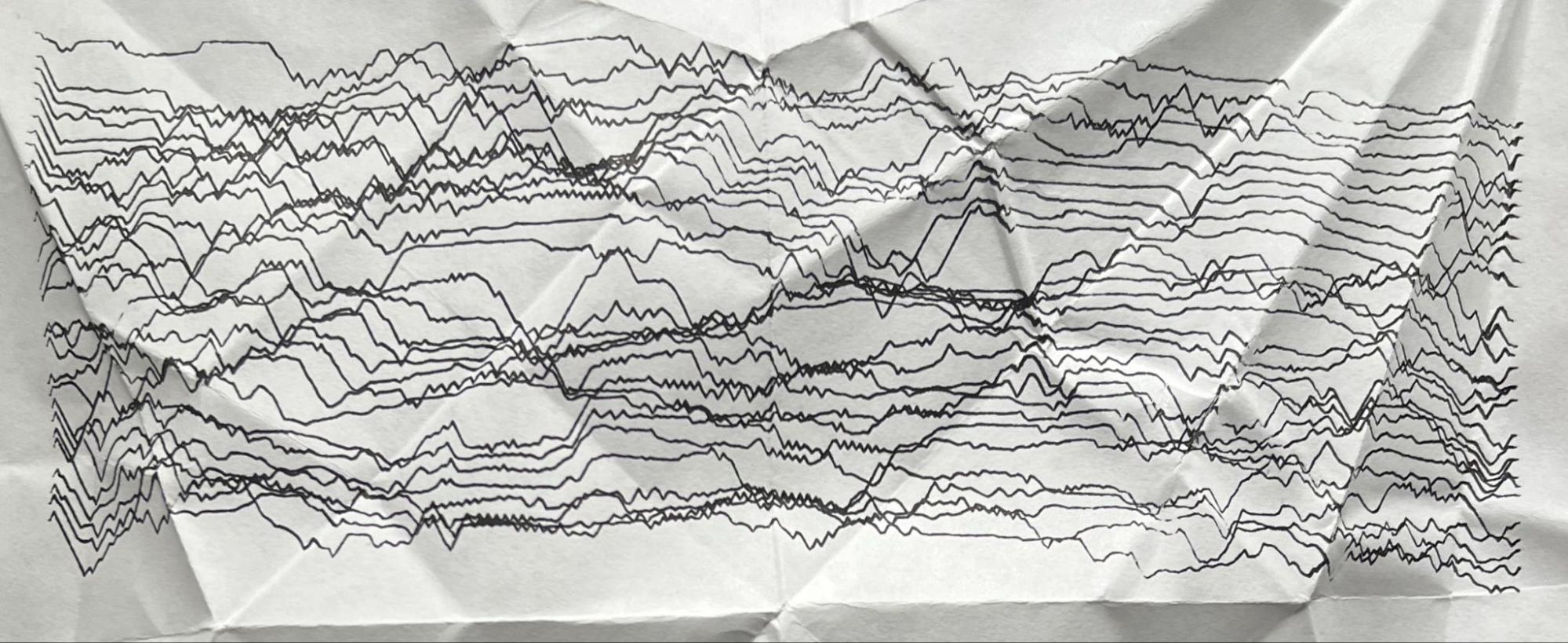 A dense field of roughly thirty wavering traces filling a crumpled sheet