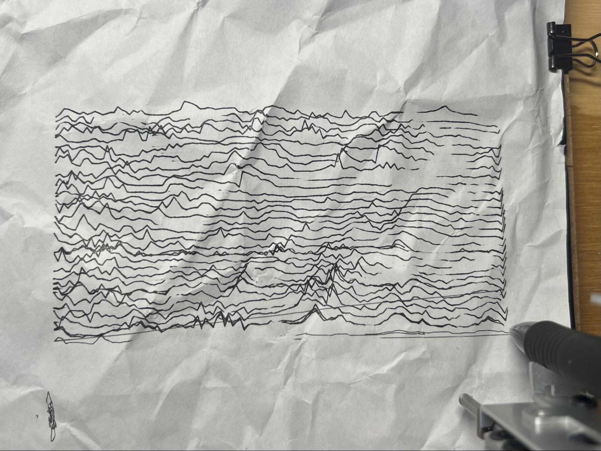 A second line field on the plotter bed, the AxiDraw rail visible at the edge of the frame