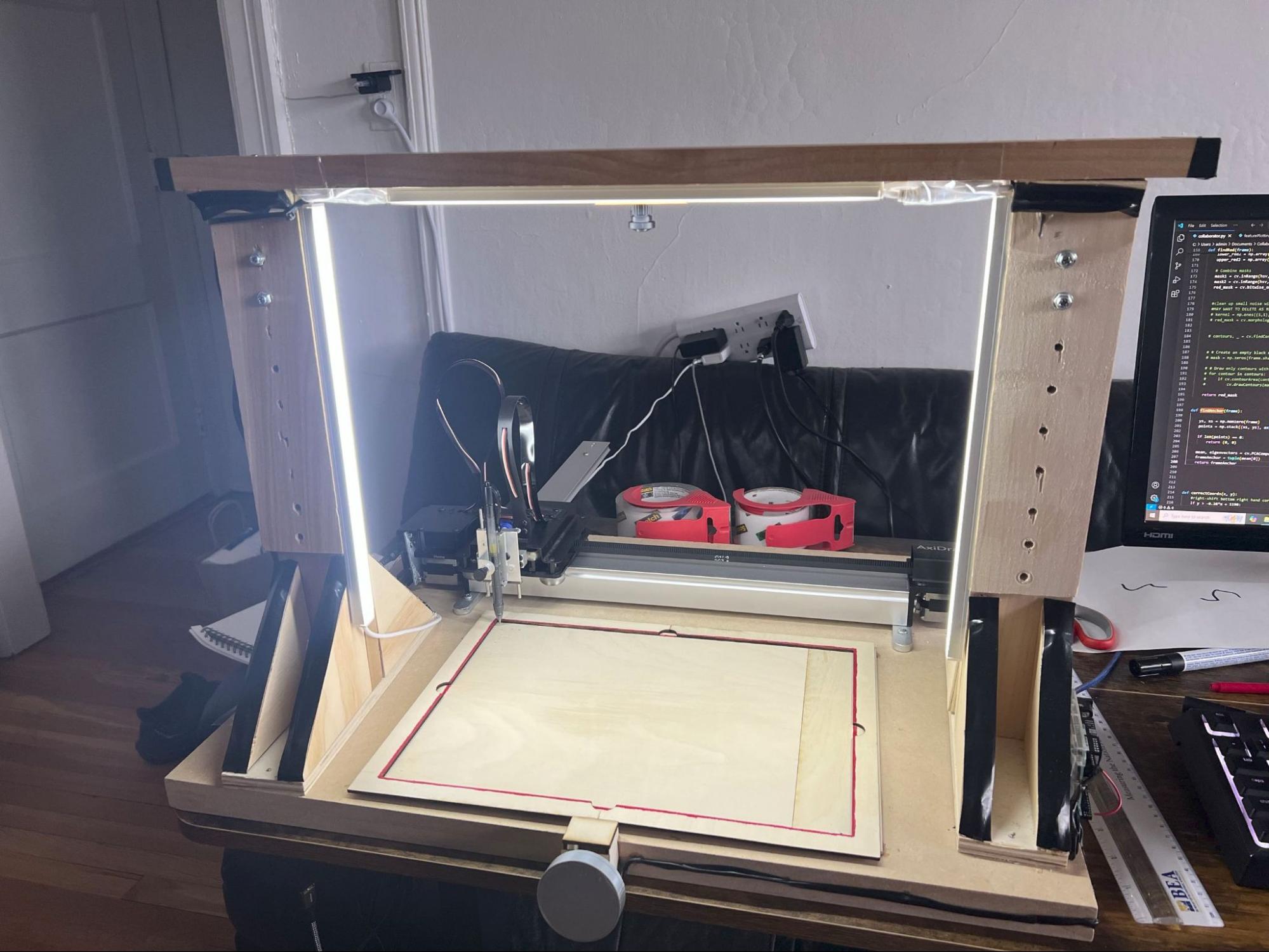 The rebuilt rig with LED strip lighting mounted on the camera bridge, illuminating the plotter bed