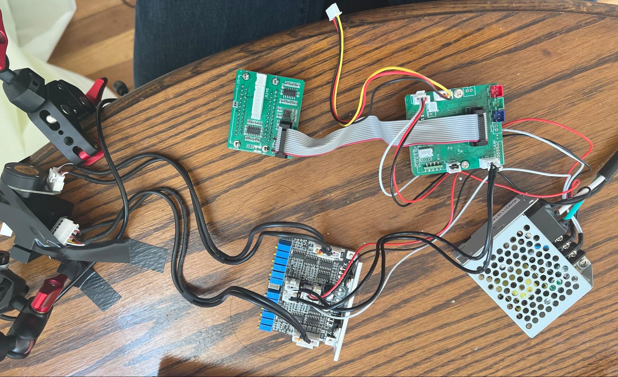 The galvo kit wired up on a table: driver board, signal boards, power supply, and the two galvo motors