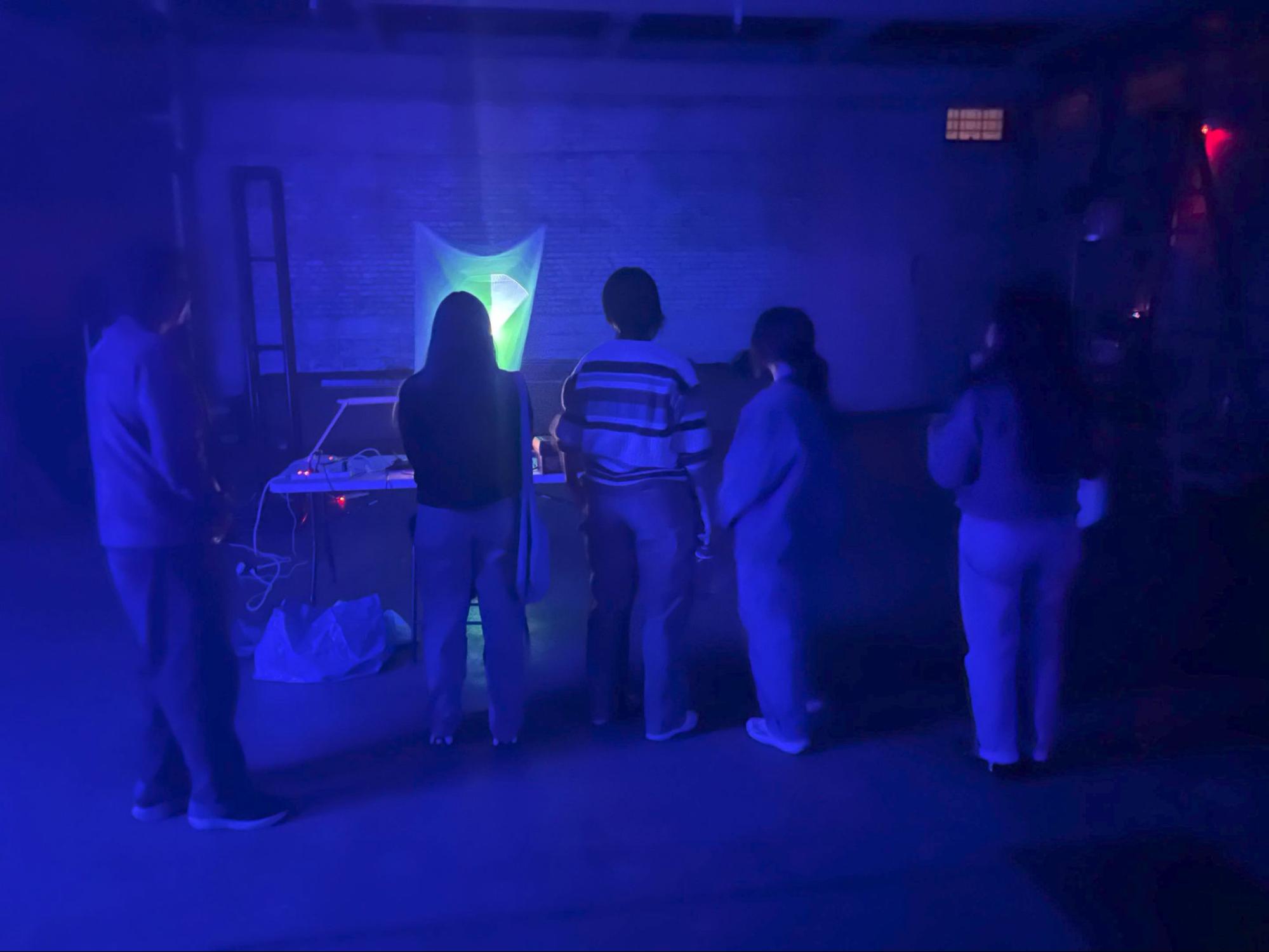 Visitors gathered around the sail and the galvo table at Tech25