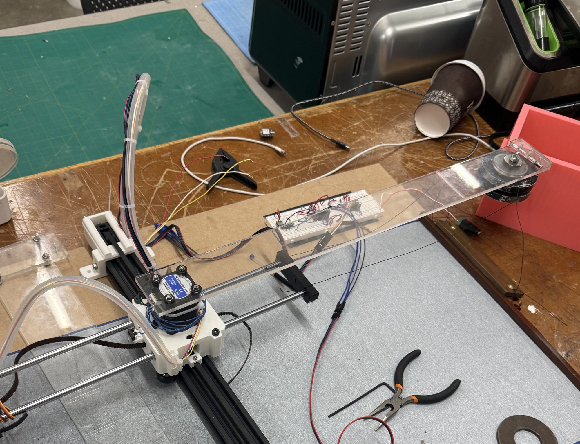 A long piece of scavenged acrylic mounted on the plotter as the counterweight pillar