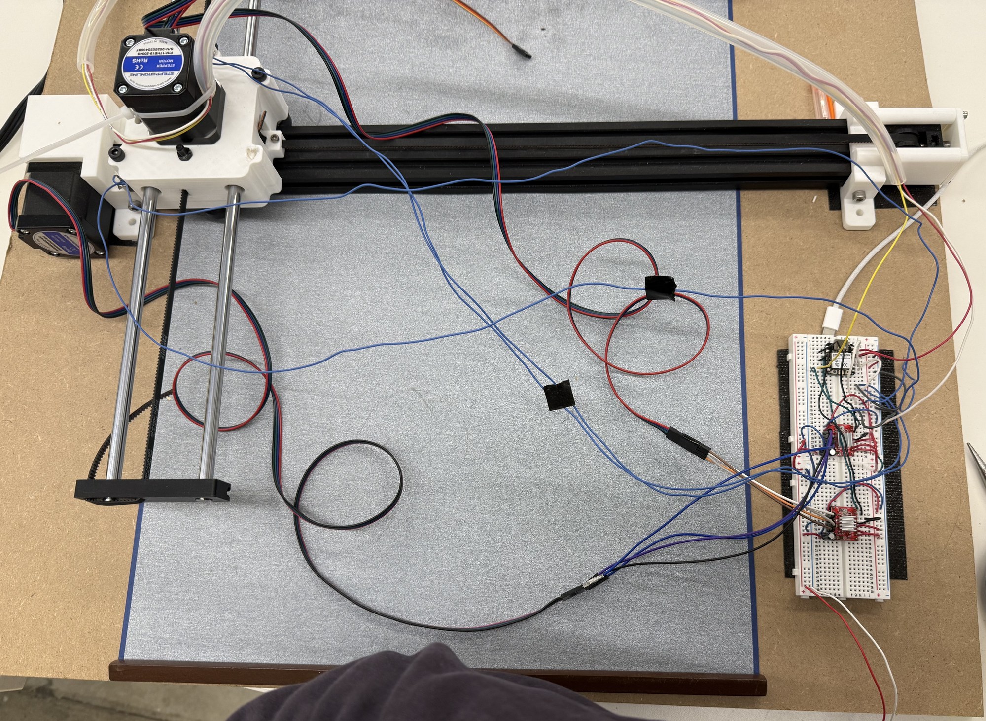 The original horizontal version on its chipboard base, with the cloth and electronics beside the plotter