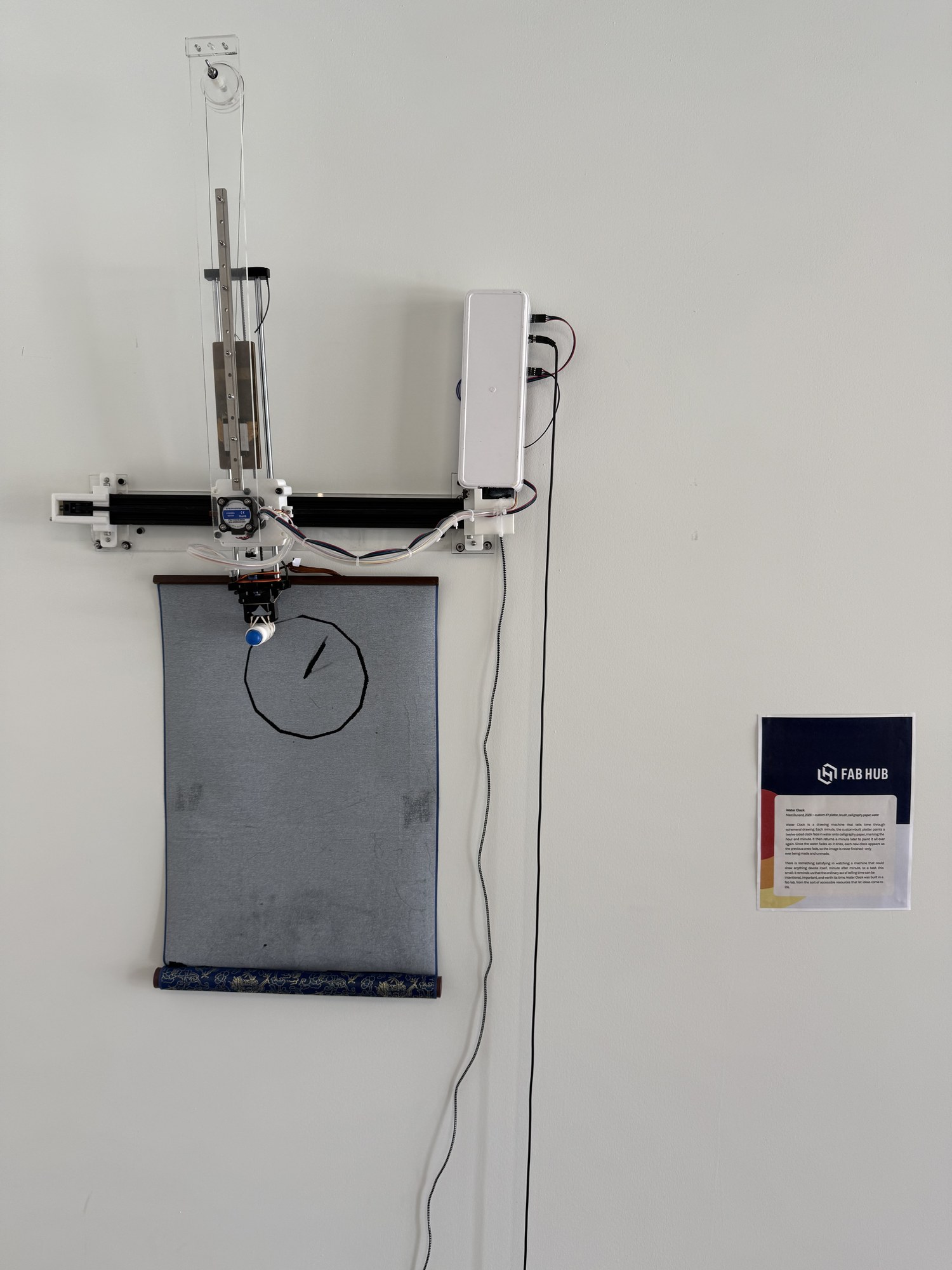 Water Clock installed on a wall at the Fab Foundation headquarters, beside its wall label